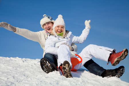 young couple having fun winter time in ski resortの写真素材