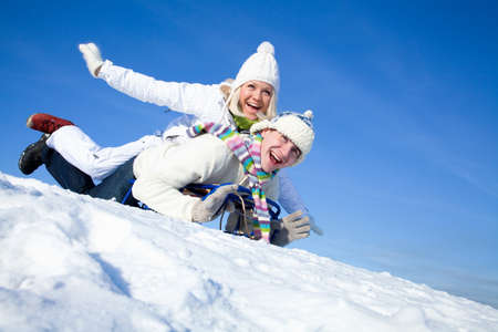 young couple having fun winter time in ski resortの写真素材