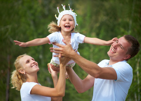Portrait of young couple with their little daughterの写真素材