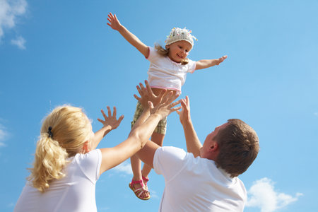 Portrait of young couple with their little daughterの写真素材