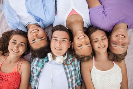 funny portrait of group of teenagers spending time togetherの写真素材