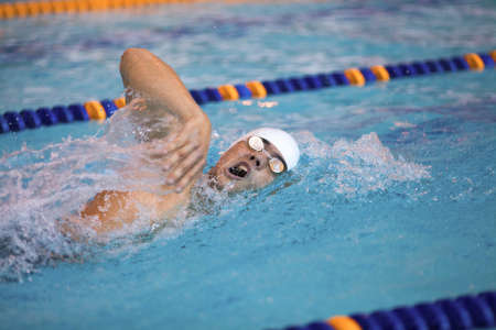 male professional competitive swimmer in swimming poolの写真素材