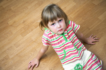 Portrait of a little offended girl at home