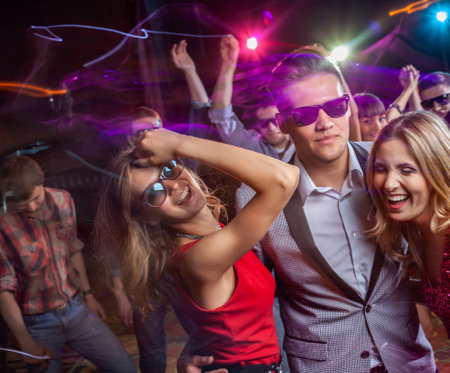 Group of young people dancing at the disco clubの写真素材