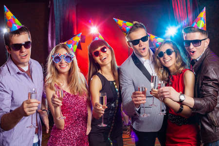 cheerful young company celebrates in a nightclubの写真素材