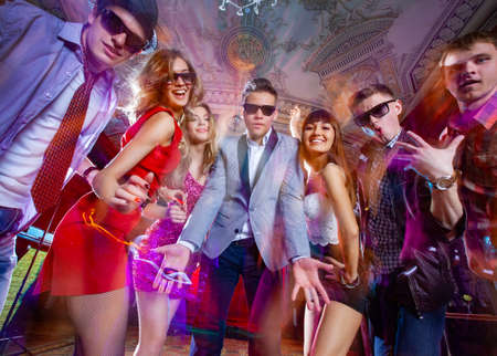 Group of young people dancing at the disco clubの写真素材