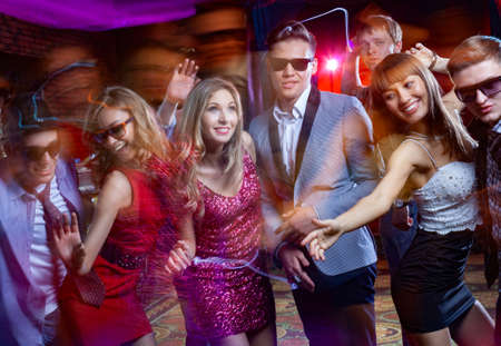 Group of young people dancing at the disco clubの写真素材