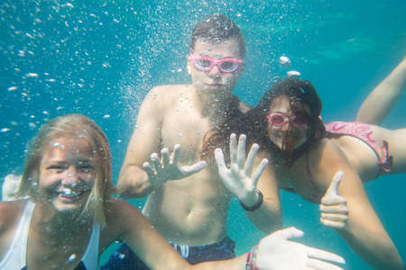portrait of teenagers dive with mask in the seaの写真素材
