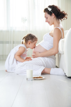 portrait of Little cute girl with her pregnant motherの写真素材