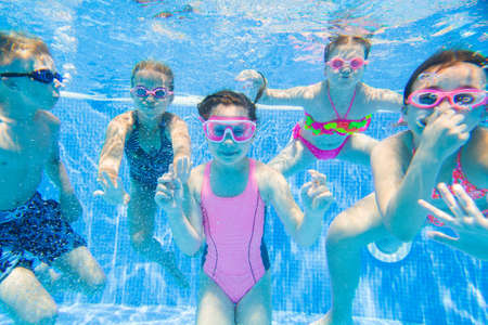 little kids swimming in pool underwater.の写真素材