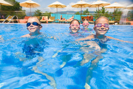 Children play fun in the pool at the resortの写真素材