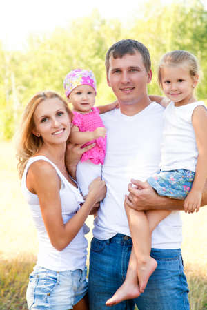 Portrait of young couple with their two little daughtersの写真素材