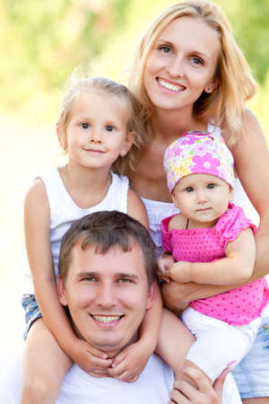Portrait of young couple with their two little daughtersの写真素材