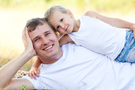 Portrait of Father and daughter having summer relaxation time togetherの写真素材