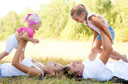 Portrait of young couple with their two little daughtersの写真素材