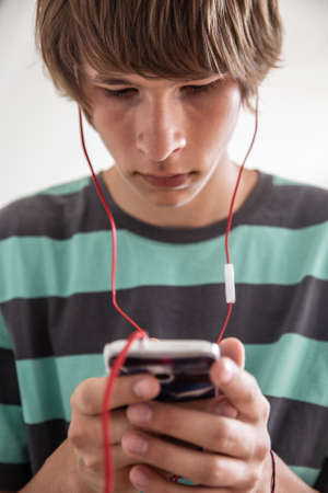 boy teenager playing with his gadget