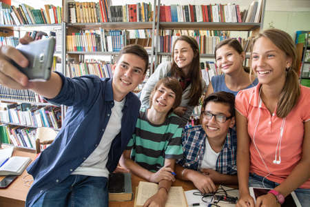 Group of students doing selfie in the classroom at schoolの写真素材