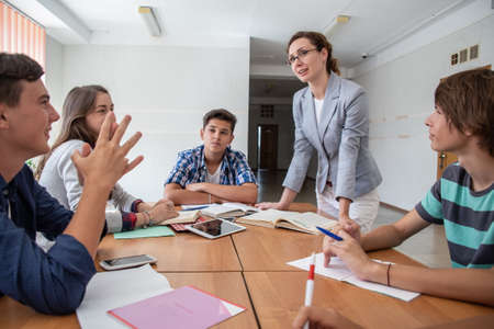 group of students learning with teacher in the classroom at schoolの写真素材