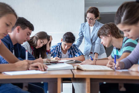 group of students learning with teacher in the classroom at schoolの写真素材