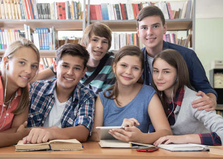group of students engaged in learning at the desk in the libraryの写真素材