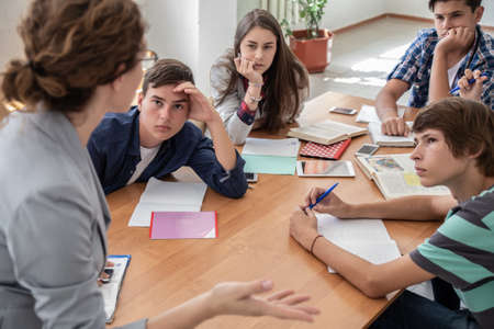 group of students listening to the teacher in the classroom at schoolの写真素材