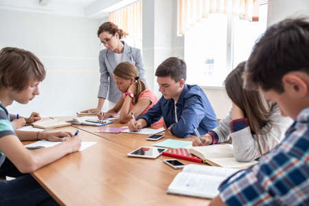 group of students learning with teacher in the classroom at schoolの写真素材