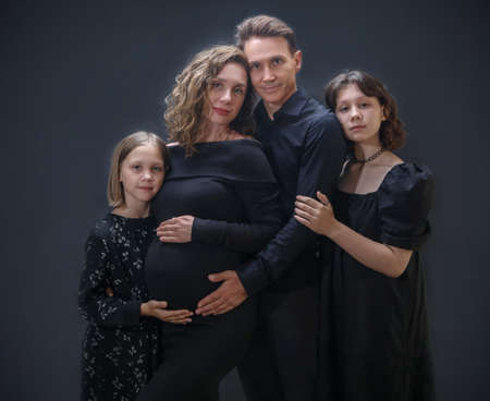 Large young family with two children and a pregnant mother expecting another babyの写真素材