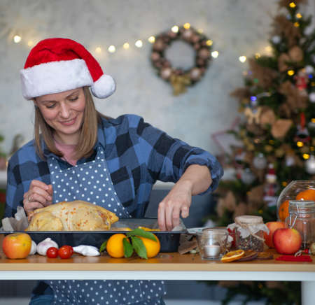 Mom prepares a festive dinner for Christmas at homeの写真素材