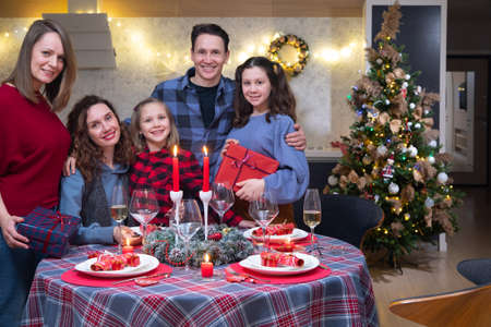 Portrait of a large family at a festively laid table at Christmasの写真素材