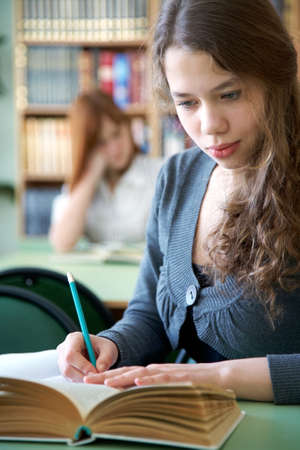 girl high school student involved in the libraryの写真素材
