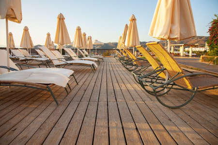 View of the terrace with sunbeds and umbrellas in a tropical resort. Nobody.の写真素材