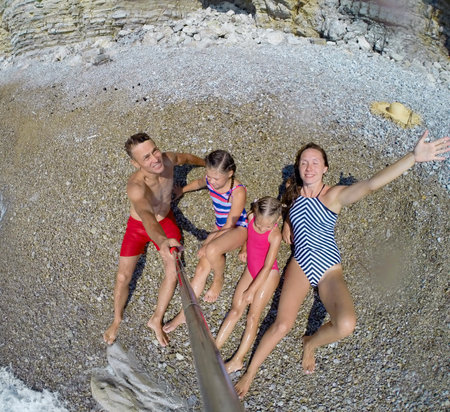 happy family having a rest on the beach of a seaの写真素材