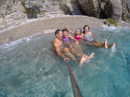 happy family having a rest on the beach of a seaの写真素材