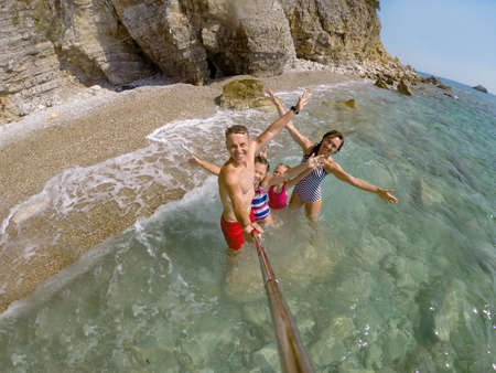 happy family having a rest on the beach of a seaの写真素材