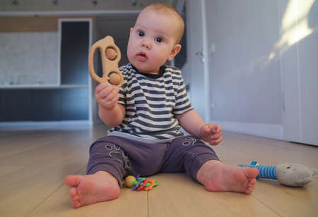 newborn baby playing on the floor aloneの写真素材