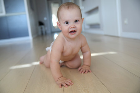 newborn baby crawling on the floor aloneの写真素材