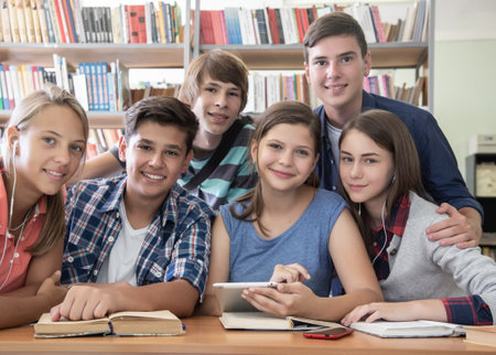 group of students engaged in learning at the desk in the libraryの写真素材