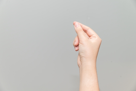 Human hand holding imaginary card on light gray backgroundの写真素材