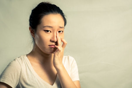 Portrait of young woman crying desperately, with fashion tone and backgroundの写真素材