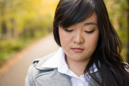Close up portrait of attractive young girl alone on a road looking depressedの写真素材