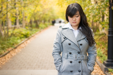 Close up portrait of attractive young girl alone on a road looking depressedの写真素材