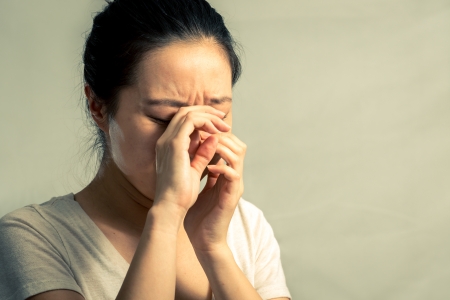 Portrait of young woman crying desperately, with fashion tone and backgroundの写真素材