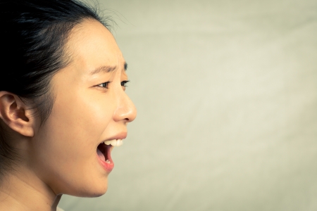Young woman shouting, with fashion tone and backgroundの写真素材