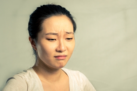Portrait of young woman crying desperately, with fashion tone and backgroundの写真素材