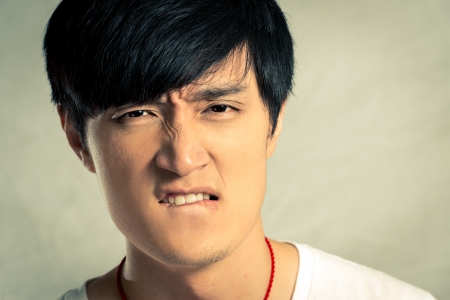 Young man looking angry and yelling, with fashion tone and backgroundの写真素材