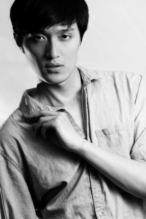 Fashion pose by a young male model, with black and white color and backgroundの写真素材