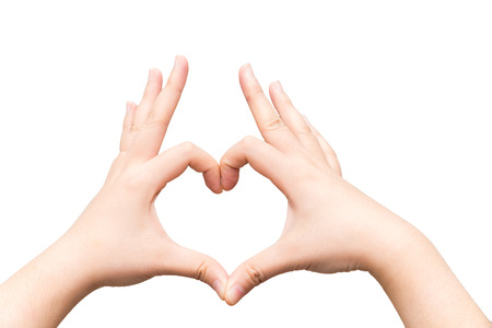 Human hands making a heart shape on light gray backgroundの写真素材