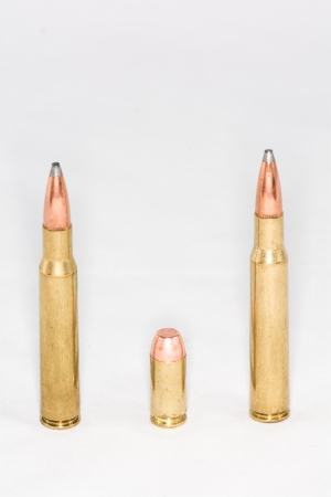 A few rifle and hand gun bullets on white background with details