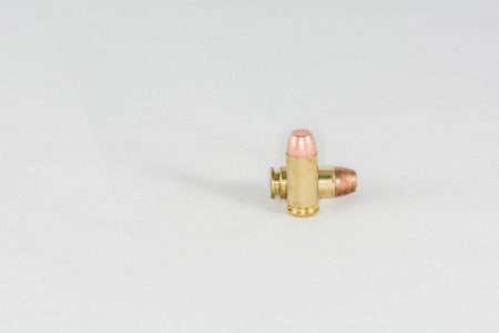 Two hand gun bullets on white background with detail