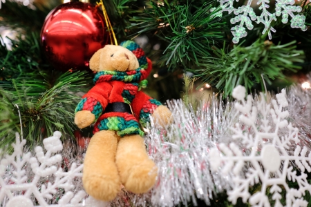 Christmas decorations and lights hanging on a Christmas treeの写真素材